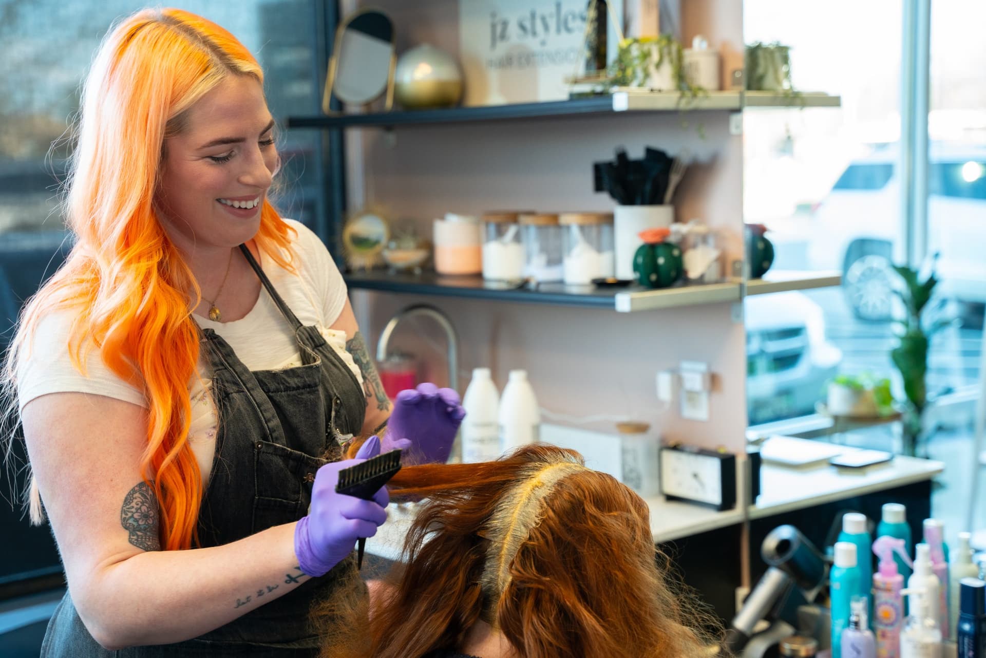Independent stylist coloring a client's hair in her own salon suite