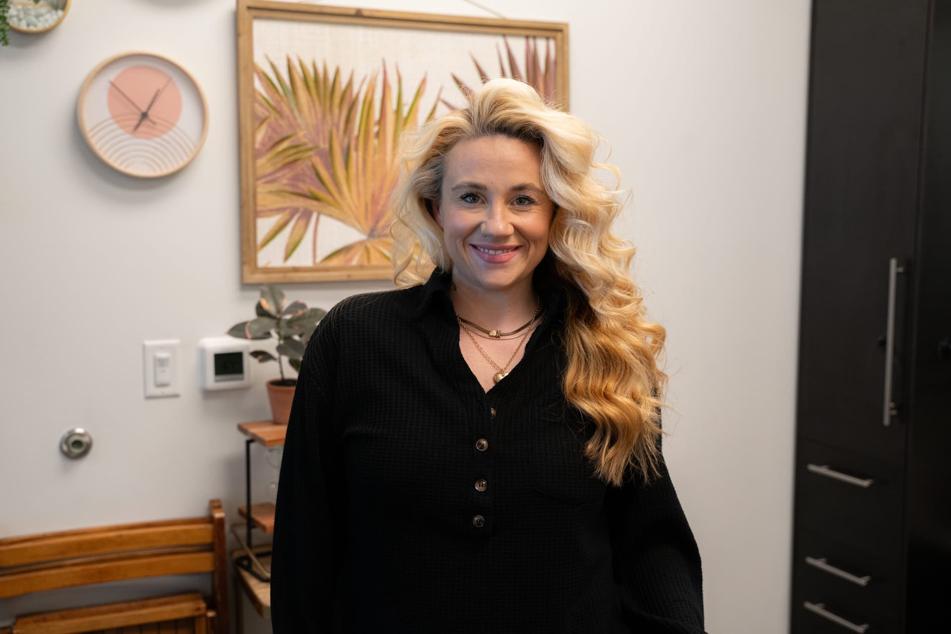 Smiling beauty professional in her salon suite at The Hive Florence